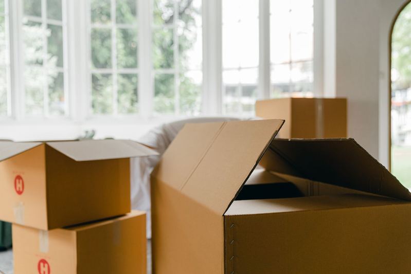 Stacked moving boxes near a bright window